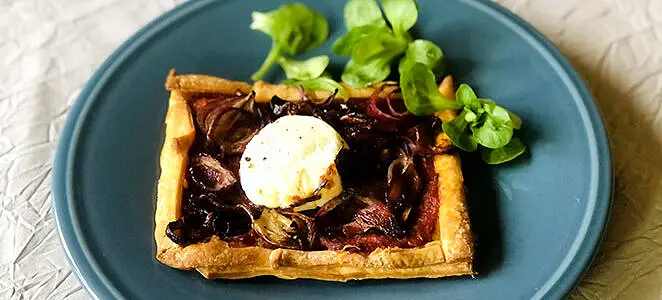 Feuilleté au chèvre chaud sur lit de tomates séchées et oignons rouges